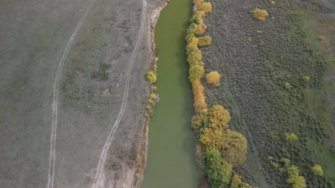 Drone flight along winding river with pronounced curve and contrasting banks Stock Footage 334329850