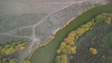Drone flight along winding river with pronounced curve and contrasting banks Stock Footage 334329883