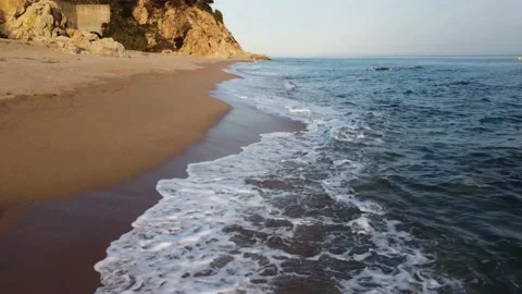 Drone flight alongside the seashore at sunset Stock Footage 172471812