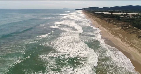 Drone flight and general view over wide beach and big waves Stock Footage 124374982