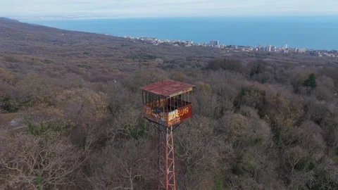 Drone flight around communication tower above forest,December 11, 2025 Stock Footage 323528368