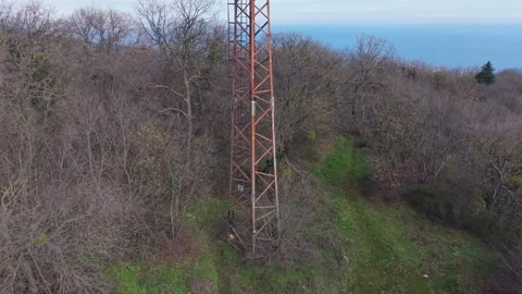 Drone flight around communication tower above forest landscape in Bulgaria Video stock 323528374
