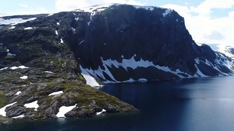 Drone flight around high mountain lake in central Norway Stock Footage 95456010