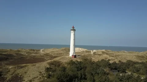 Drone flight around Lyngvig lighthouse on Denmarks North Sea coast Stock Footage 87254673