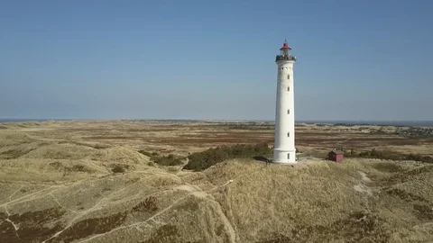Drone flight around Lyngvig lighthouse on Denmarks North Sea coast Stock Footage 87254848