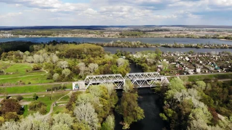 Drone flight around the railway bridge over the river in a picturesque location Stock Footage 154293087