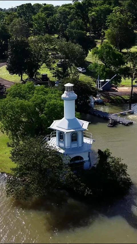 Drone Flight Around White Lighthouse on Scenic Lakeside Peninsula Video stock 346910941