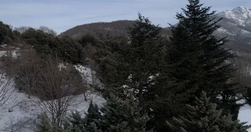 Drone flight back over a little monastery on the snowy mountain Stock Footage 85890732