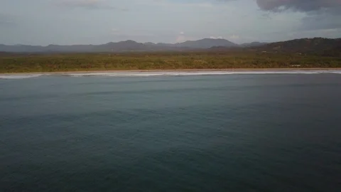 Drone flight back to shore of Playa Grande Costa Rica Stock Footage 90973160