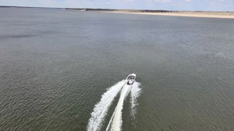 Drone flight behind a boat over the Volga river on a sunny April day Video stock 197646520