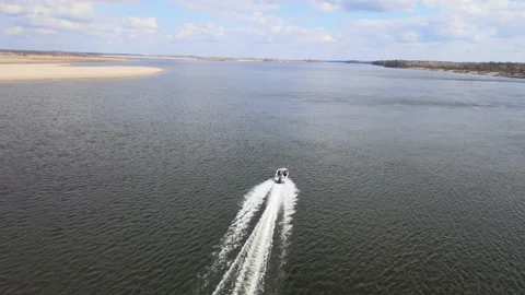 Drone flight behind a boat over the Volga river on a sunny April day Video stock 197646570