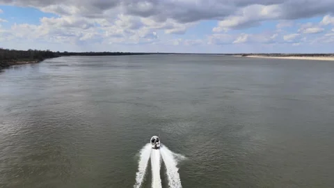 Drone flight behind a boat over the Volga river on a sunny April day Video stock 197646623