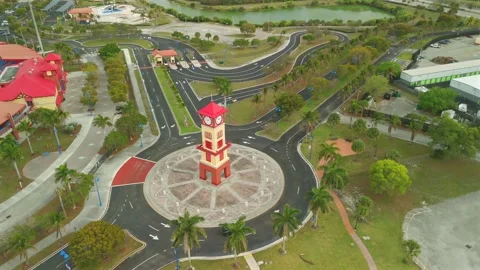 Drone Flight Circling Red And Beige Clock Tower In Lauderhill Florida Stock Footage 339063780