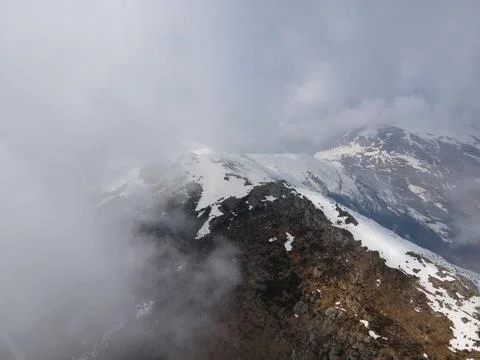 Drone flight into the clouds in natural mountains environment. people hiking Stock Photos