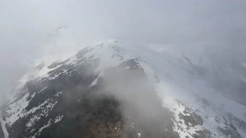Drone flight into the clouds in natural snowy mountains landscape. alps 4k Stock Footage 150871771