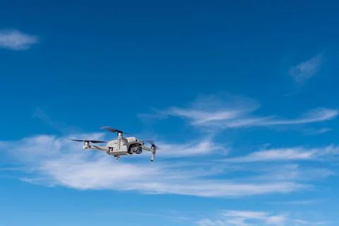 Drone in flight dynamics against the sky Stock Photos