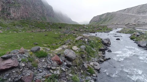 Drone flight extremely low over stormy mountain river. Aerial view. 스톡 동영상 91016168