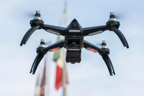 Drone in flight with flags in the background Stock-Fotos