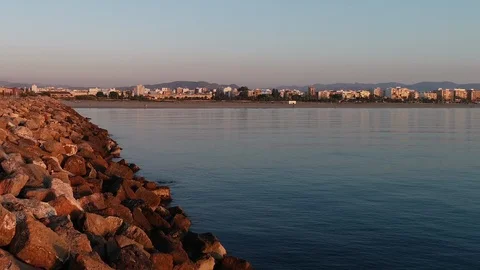 Drone flight flying over a lonely breakwater next to the calm sea Stock Footage 124220653