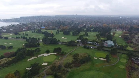 Drone flight of golf course and town in background Stock Footage 127002915