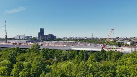 Drone flight from green park towards London skyline and construction site Stock Footage 309762275