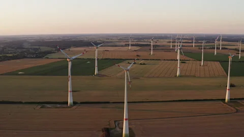 Drone flight at high altitude over a large field with many wind turbines Stock Footage 163097599