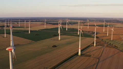 Drone flight at high altitude over a large field with many wind turbines Stock Footage 163097731