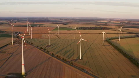 Drone flight at high altitude over a large field with many wind turbines Stock Footage 163098015