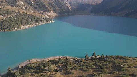 Drone flight high in the mountains above the lake Stock Footage 139974353