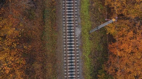 Drone flight in an industrial area. A freight train loaded with wood moves Stock Footage 230998220