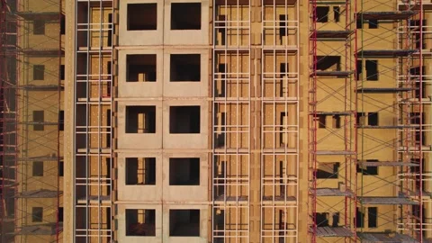 Drone flight from left to right at a construction site unfinished buildings Видео 205259972