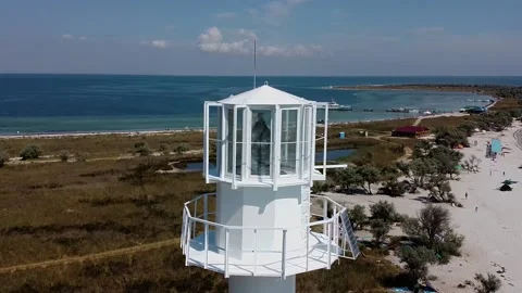 Drone flight from the lighthouse overlooking the coastline of the island Stock Footage 144617545