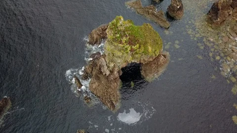 Drone flight looking down on a Sea stack Stock Footage 111654457