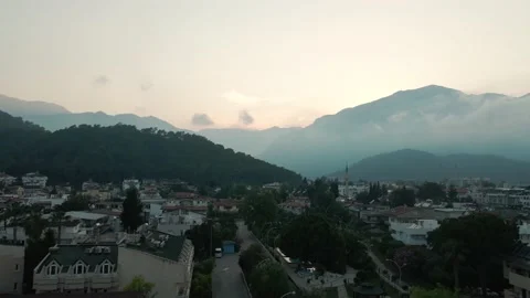 Drone flight, mountains in the clouds, city by the sea 4k Stock Footage 214918425