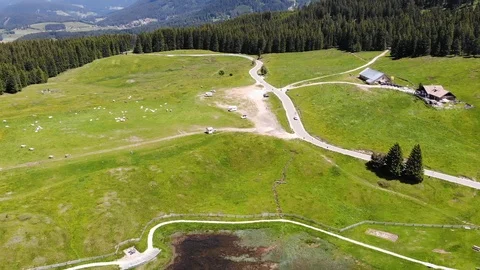 Drone flight over an alpine meadow and a lake Stock Footage 112332600