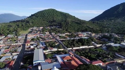 Drone flight over Apaneca Town revealing it church Stock Footage 100799396