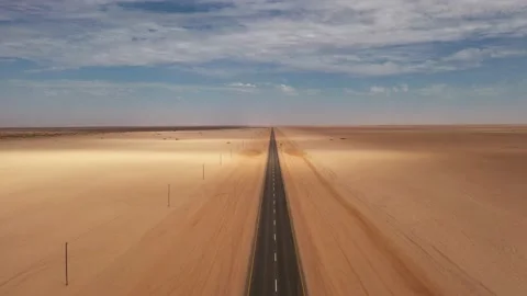 Drone flight over asphalt road through desert of Namib Video stock 157767344