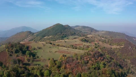 Drone flight over an autumn mountain with peaks, meadows and colorful forests Stock Footage 146166108