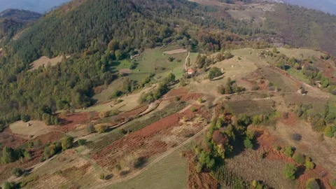 Drone flight over an autumn mountain with peaks, meadows and colorful forests Stock Footage 146166439