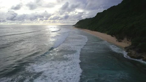 Drone Flight Over Bali's Waves and Tropical Forest Stockbeeldmateriaal 237468686