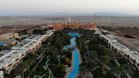 Drone flight over a beautiful pool and palm trees in Egypt Stock Footage 129243169