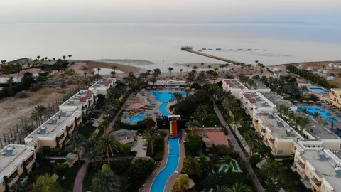 Drone flight over a beautiful pool and palm trees in Egypt Stock Footage 129244613