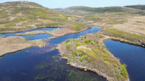 Drone Flight Over Blue Lake with Adjoining Meadows Stock Footage 253471190