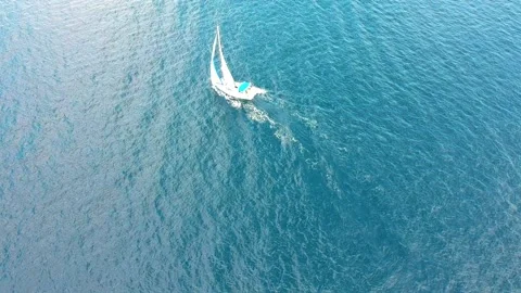 Drone flight over boat sailing through deep blue ocean and calm water Stock Footage 234335166