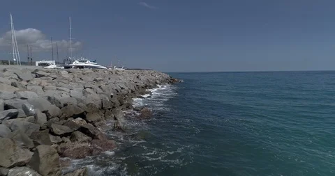 Drone flight over breakwater of nautical port in the Mediterranean Sea Stock Footage 88105047