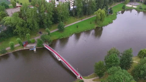 Drone flight over the bridge on which a beautiful bride and father goes to the Stock Footage 130648116