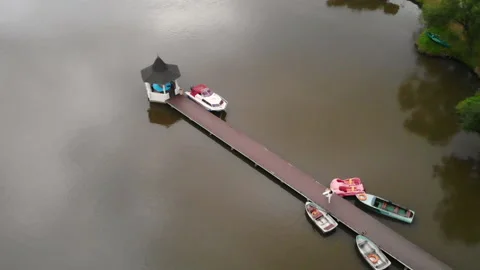 Drone flight over the bridge on which walks a happy woman in white clothes Stock Footage 130649702