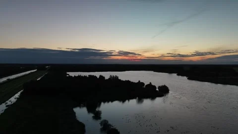 Drone Flight Over Calm Lake at Sunrise in the Netherlands – 4K Stock Footage 317847468