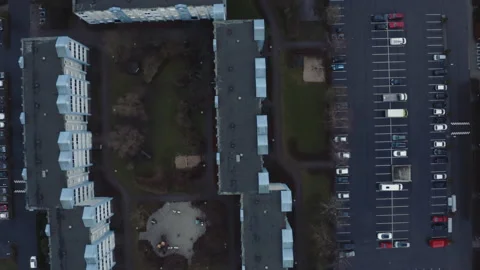Drone Flight Over Carpark And Flats Stock Footage 133446913