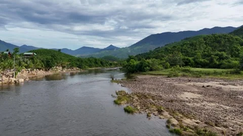 Drone Flight Over a Clear Peaceful Stream and Rocky Riverbank Vídeo Stock 343720122